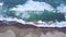 Beautiful aerial footage of frothy wave on beach