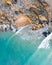 Beautiful aerial image of a seaside village with small beach and gentle blue waves