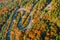 Beautiful aerial landscape of mountain forest road. Aerial view of curvy road in beautiful autumn forest