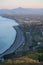 Beautiful aerial-like evening view of Killiney Beach, coastal line and railway seen from Killiney Hill during golden hour, Dublin