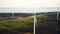 Beautiful aerial panorama of windmill turbine farm standing still in autumn forest lake field, eco-friendly power source
