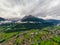 Beautiful aerial panoramic view of the Dolomites Alps, Italy. Mountains covered by clouds and fog. Catinaccio mountain ranges.