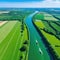 A beautiful aerial picture of verdant meadows and the Seine River in rural Northern Ile de Val