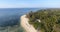 Beautiful aerial shot of tropical island green palm tree forest in Pacific ocean with waves splashing, Stunning drone