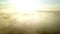 Beautiful aerial video above very thick clouds foggy sunrise over forest landscape in North Sweden - golden sun light
