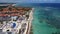 Beautiful aerial view of a beach with hotels and the Caribbean Sea during sunrise