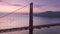 Beautiful aerial view of Golden Gate Bridge at epic rose purple sky background
