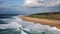 Beautiful aerial view of the large and deserted beach in small town Nazare, Portugal. Beautiful huge waves, sandy beach