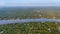 Beautiful aerial view of Mekong Delta countryside, coconut land with vast coconut, nipa palm jungle, riverside house and waterway