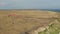 Beautiful aerial view on the seashore and a person paragliding