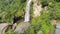 Beautiful Aerial Waterfall with Rocks in a Mountain Slow Circle Panned Shot