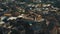 Beautiful aerial zoom out, happy traveler couple having breakfast at rooftop cafe enjoying sunny ancient town panorama.