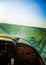 A beautiful aero landscape of a Baltic sea looking out of a small plane cockpit. Riga, Latvia, Europe in summer. Authentic flying