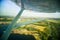 A beautiful aero landscape looking out of a small plane window under the wing. Riga, Latvia, Europe in summer. Authentic flying ex