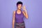 Beautiful african american afro woman wearing casual sportswear over purple background smiling positive doing ok sign with hand