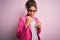 Beautiful african american businesswoman wearing jacket and glasses over pink background Ready to fight with fist defense gesture,