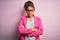 Beautiful african american businesswoman wearing jacket and glasses over pink background skeptic and nervous, disapproving