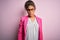 Beautiful african american businesswoman wearing jacket and glasses over pink background skeptic and nervous, frowning upset