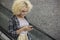 Beautiful African American girl looking in smartphone and smiling while standing on escalator