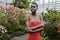 beautiful african american girl with short hair in red dress posing in garden