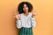 Beautiful african american woman with afro hair wearing scholar skirt showing and pointing up with fingers number nine while