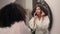 Beautiful African American woman ethnic girl in bath home looking at mirror reflection apply powder for face make up