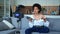 Beautiful African American woman freelancer blogger records video using a camera on a tripod, holds a drone quadcopter