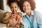 Beautiful African American woman and her daughter coloring Easter eggs