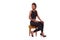 Beautiful African American woman sitting on a stool isolated on