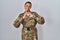 Beautiful african american woman wearing camouflage army uniform smiling in love doing heart symbol shape with hands