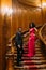 Beautiful african couple posing on the vintage stairs. Luxurious theatre interior background