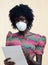 Beautiful African Doctor Noting Patient Illness Wearing Face Mask Medical Equipment to avoid contamination