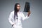 Beautiful african doctor woman with X-ray of lungs, fluorography, roentgen  on gray background. Healthcare personnel,