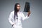 Beautiful african doctor woman with X-ray of lungs, fluorography, roentgen isolated on gray background. Healthcare personnel,
