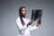 Beautiful african doctor woman with X-ray of lungs, fluorography, roentgen isolated on gray background. Healthcare personnel,