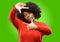 Beautiful african woman with curly hair isolated over green background
