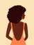 Beautiful african woman with curly hair in peach dress with open back looking over her shoulder