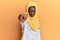 Beautiful african young woman wearing doctor uniform and hijab pointing displeased and frustrated to the camera, angry and furious