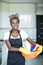 Beautiful afro american woman with basin of cleaning supplies