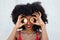 Beautiful afro-american woman covers her eyes with a pair of cyber coins. Concept bicoin, internet, online investment
