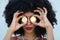 Beautiful afro-american woman covers her eyes with a pair of cyber coins. Concept bicoin, internet, online investment