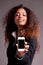 Beautiful afroamerican woman showing phone