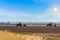 Beautiful agricultural landscape with two old tractors equipped with seeders.