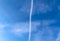 Beautiful aircraft vapor trails in a blue sky