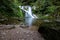 Beautiful allerheiligen waterfall in the forest. Germany Black Forest. Long quote exposure and trees. Cliff river