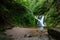 Beautiful allerheiligen waterfall in the forest. Germany Black Forest. Long quote exposure and trees. Cliff river