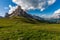 Beautiful alpine countryside. Scenic image of famous Sassolungo peak with overcast perfect blue sky. Wonderful Vall Gardena under
