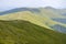 Beautiful alpine grassy meadow with forest on hillside in Carpathians