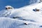 Beautiful alpine landscape with chalets, snow, sun and shadows in the Carpathians Mountains