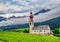 Beautiful alpine scenery of Vallabassa town with St. Stephen& x27;s church, Dolomite Alps, Italy